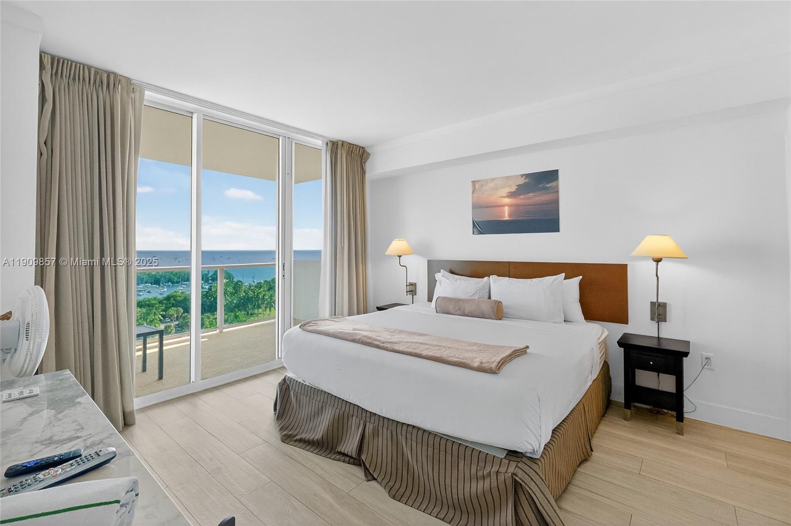 2889 McFarlane Road, Unit 1001 Miami, FL 33133 - Photo 12 of 35 a bedroom with a large bed and a large window