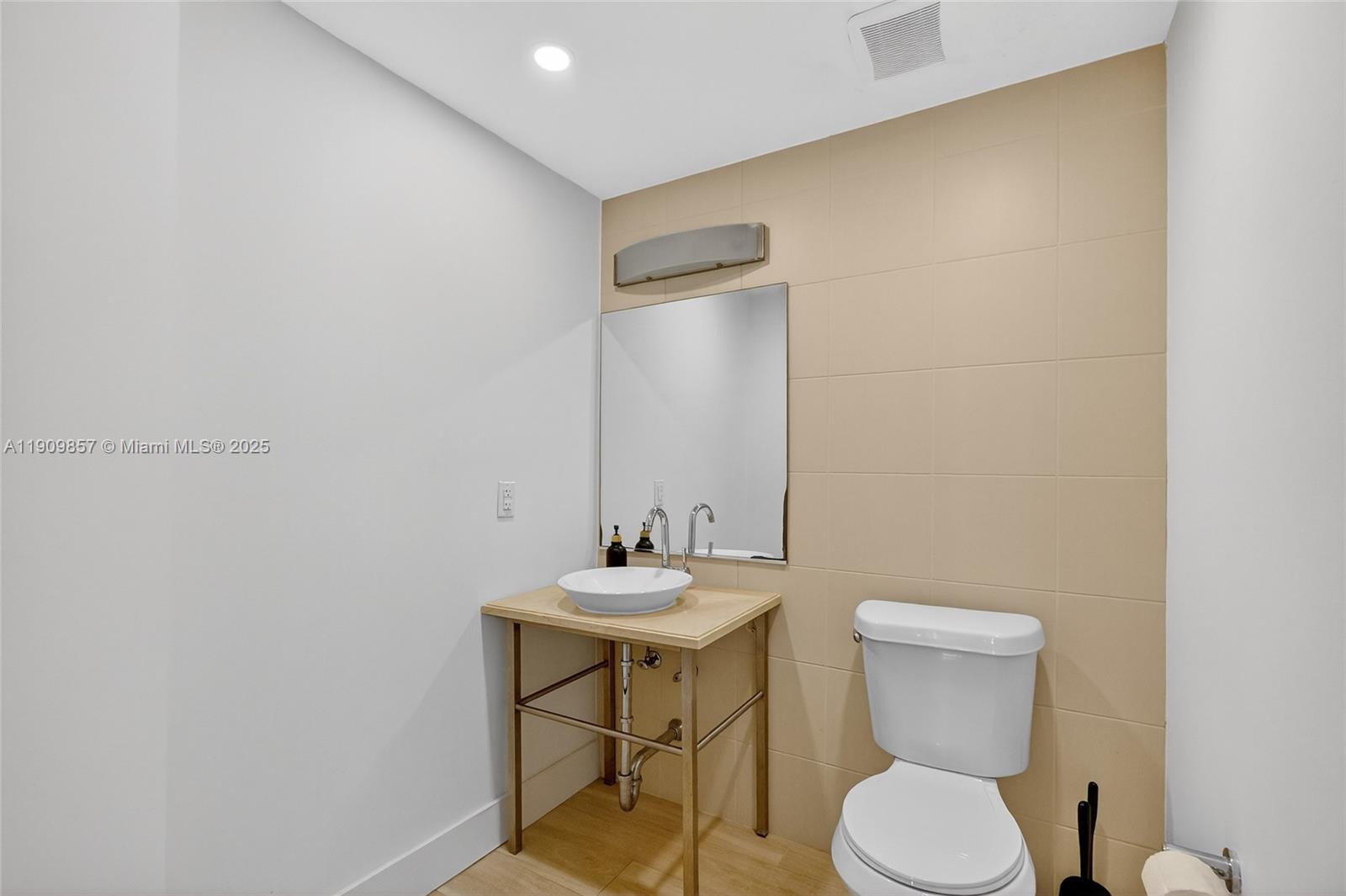 2889 McFarlane Road, Unit 1001 Miami, FL 33133 - Photo 17 of 34 a bathroom with a sink and a toilet