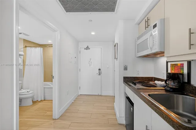a kitchen with stainless steel appliances granite countertop a sink and cabinets