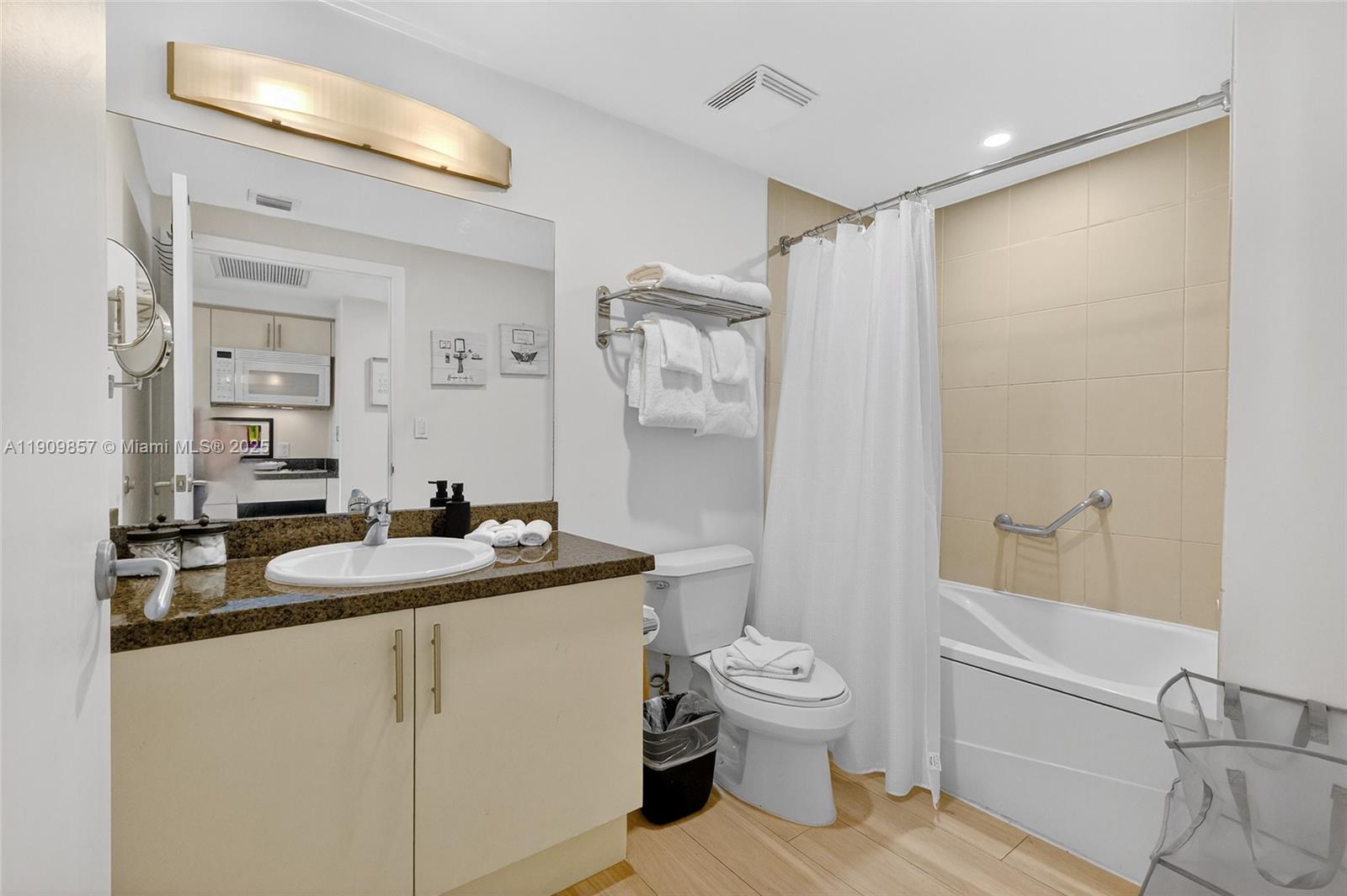 2889 McFarlane Road, Unit 1001 Miami, FL 33133 - Photo 21 of 34 a bathroom with a granite countertop sink toilet and shower