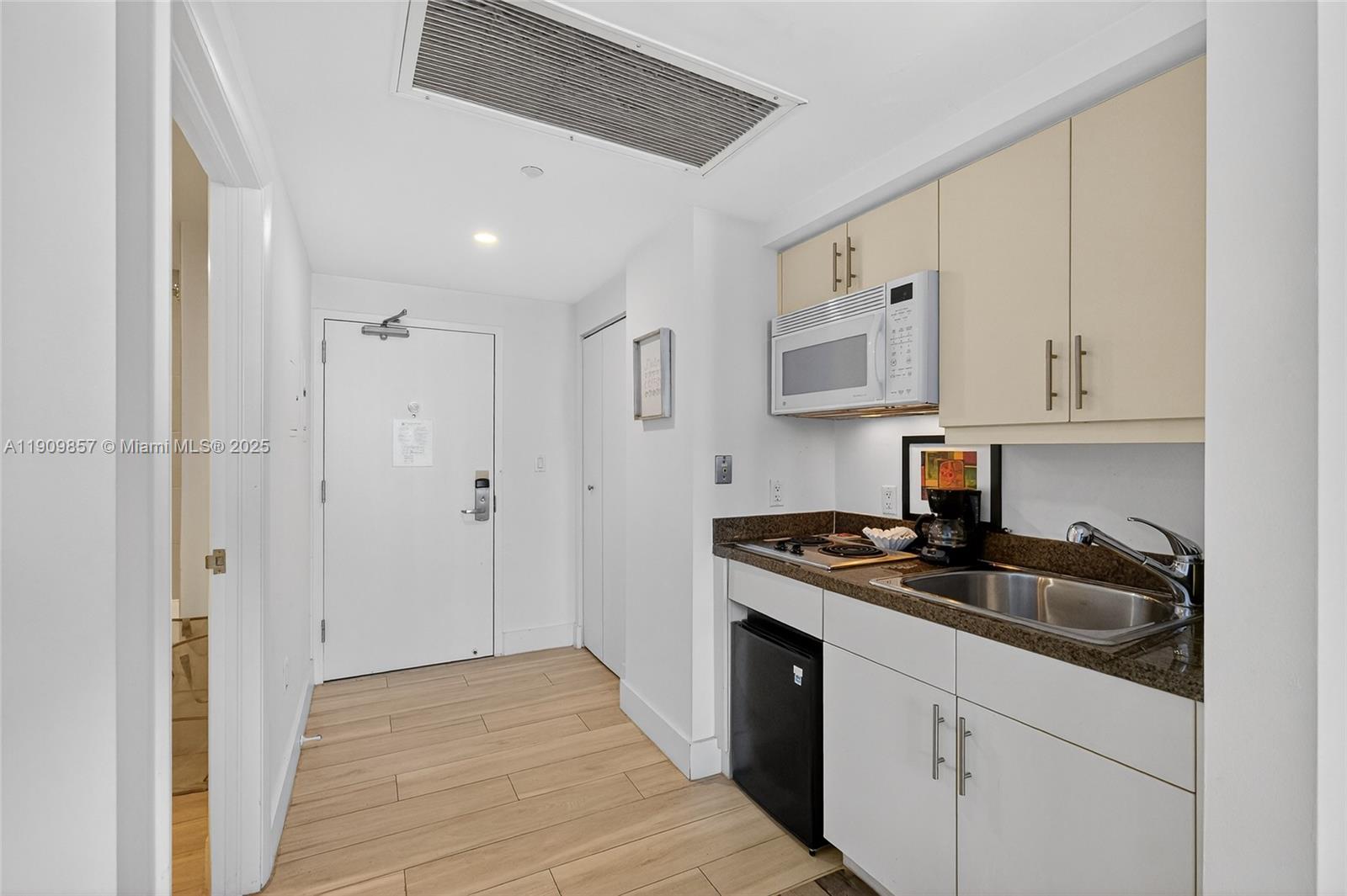 2889 McFarlane Road, Unit 1001 Miami, FL 33133 - Photo 22 of 34 a kitchen with stainless steel appliances granite countertop a stove and a refrigerator