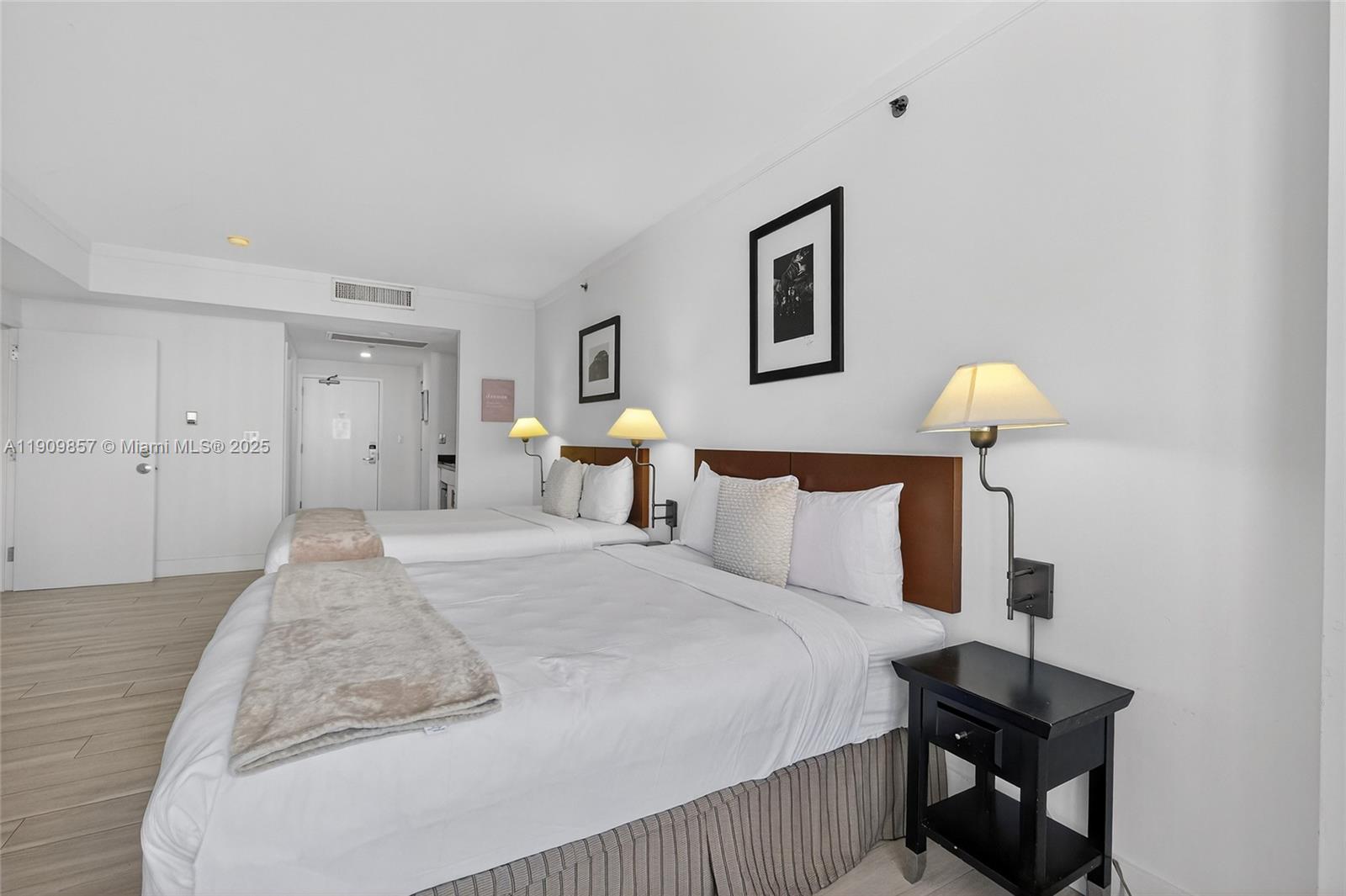 2889 McFarlane Road, Unit 1001 Miami, FL 33133 - Photo 25 of 35 a bedroom with a bed and a lamp on table