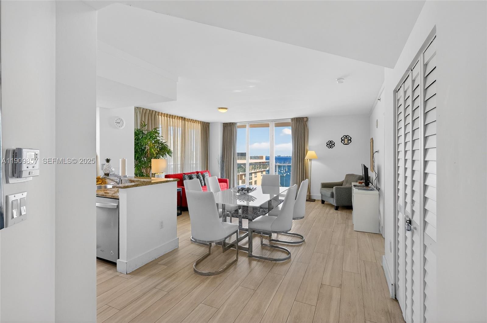 2889 McFarlane Road, Unit 1001 Miami, FL 33133 - Photo 7 of 34 a living room with furniture and a wooden floor