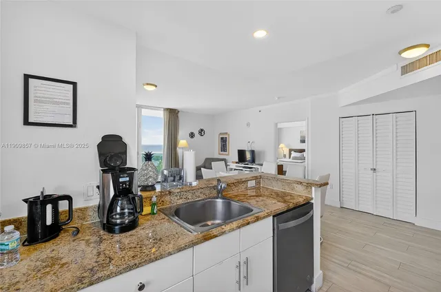 a kitchen with a sink and a mirror
