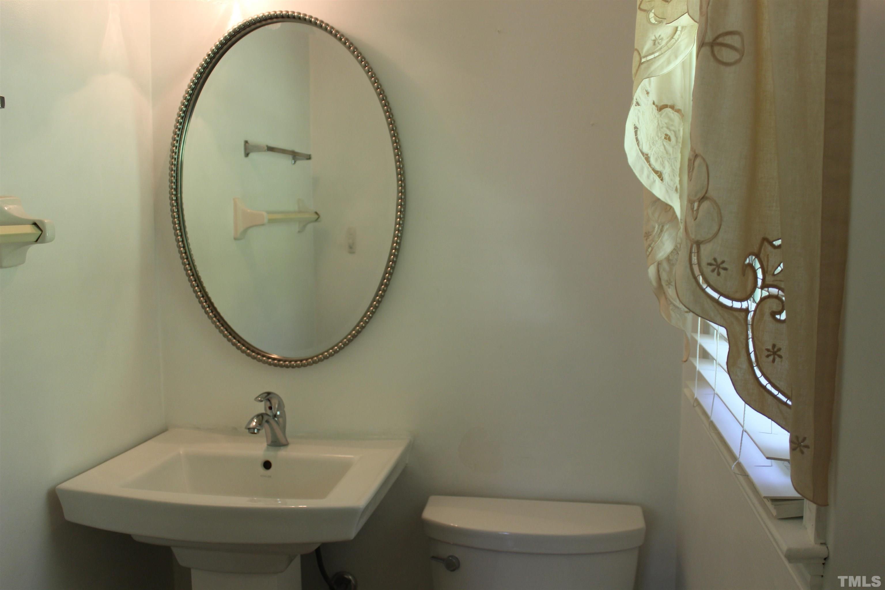 6907 Innesbrook Way Bahama, NC 27503 - Photo 9 of 17 a bathroom with a sink and mirror