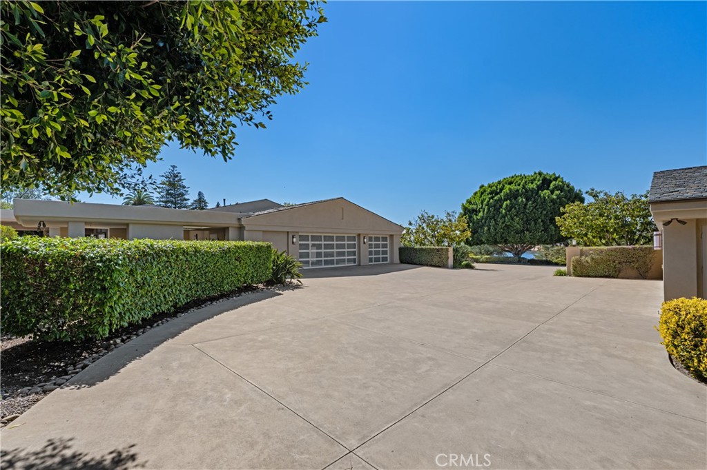 6533 Lago Lindo Rancho Santa Fe, CA 92067 - Photo 56 of 57 a front view of a house with a yard and garage