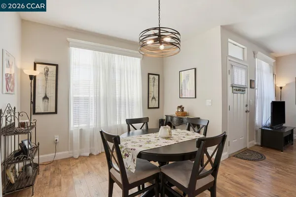 a view of a dining room with furniture and wooden floor