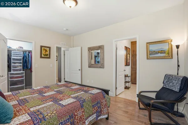 a bedroom with a bed and a chair