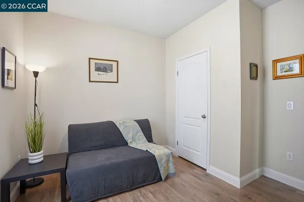 a bedroom with a bed and a lamp