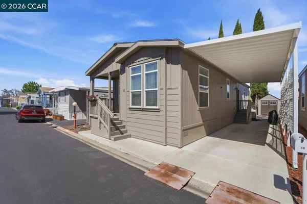 a front view of a house with parking area