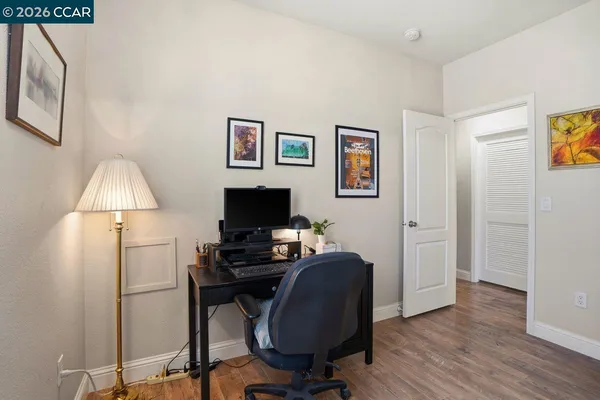 a view of a workspace with furniture and a window