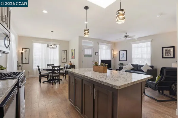 a kitchen with a table chairs and white cabinets