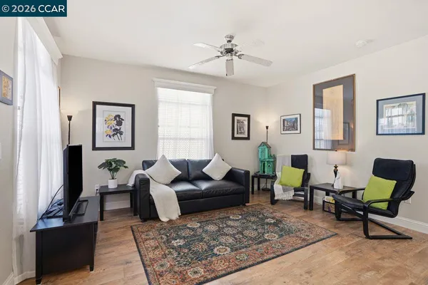 a living room with furniture and wooden floor