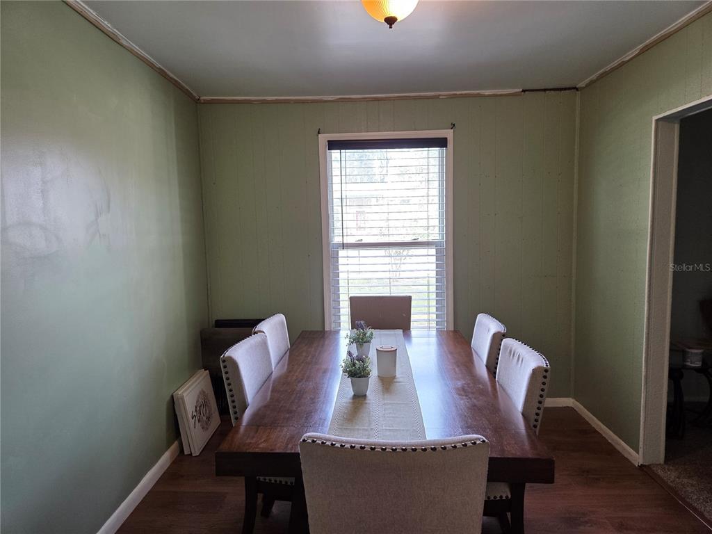 124 East F Street Frostproof, FL 33843 - Photo 10 of 37 a view of a dining room with furniture window and wooden floor