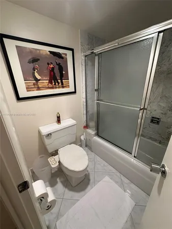a bathroom with a toilet a sink and a shower