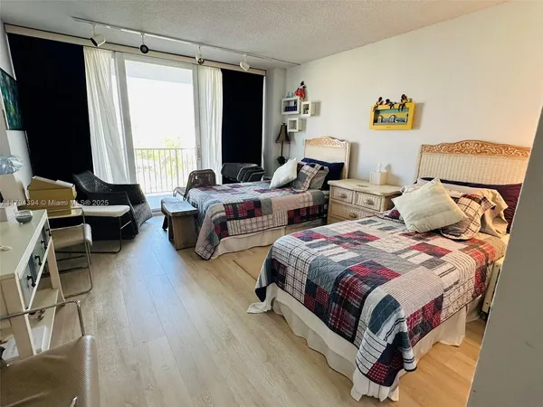 a bedroom with two beds and a large window