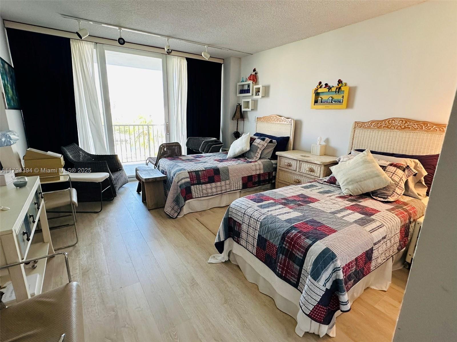 4750 South Ocean Boulevard, Unit 401 Highland Beach, FL 33487 - Photo 2 of 47 a bedroom with two beds and a large window