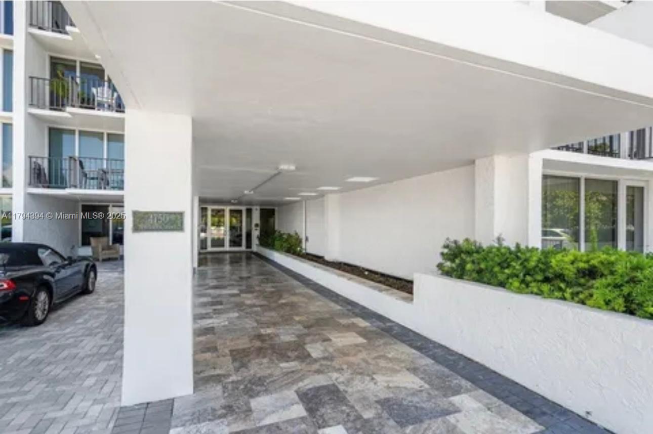 4750 South Ocean Boulevard, Unit 401 Highland Beach, FL 33487 - Photo 32 of 47 a view of a patio with furniture and garden