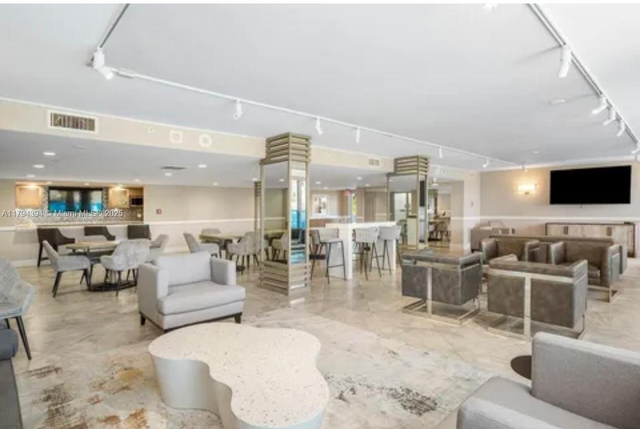 4750 South Ocean Boulevard, Unit 401 Highland Beach, FL 33487 - Photo 40 of 47 a living room with fireplace furniture and a flat screen tv