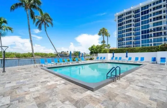 a view of a swimming pool with an outdoor space and seating area
