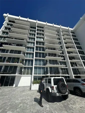 a view of a balcony with lots of car parked