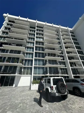 a view of a balcony with lots of car parked