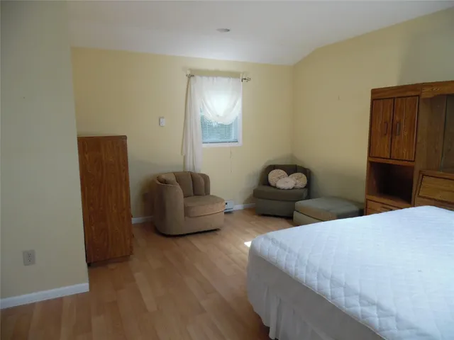 a view of an empty room with window and fire place