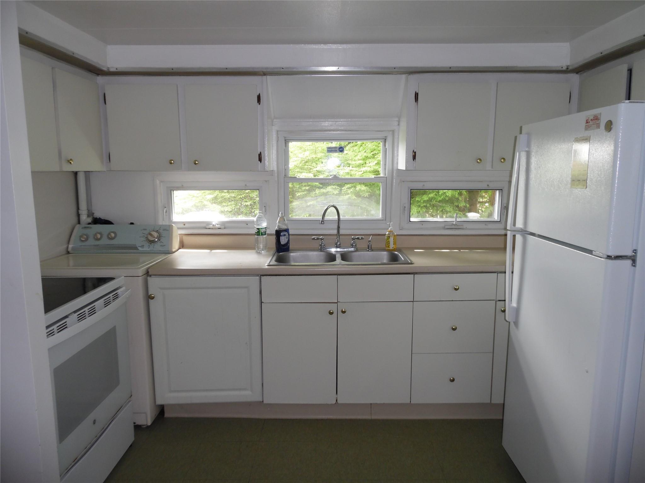 8 Crumley Van Vactor Road Ferndale, NY 12734 - Photo 9 of 24 a kitchen with white cabinets and window