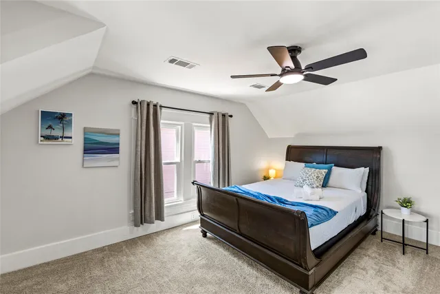 a bedroom with a bed and a ceiling fan