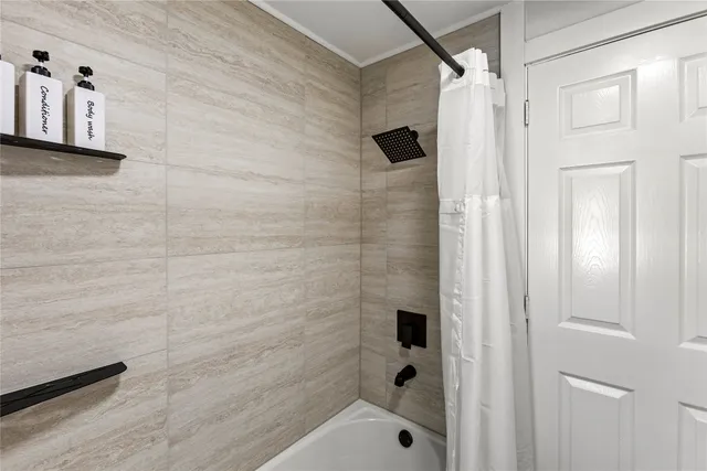a bathroom with a shower and a sink
