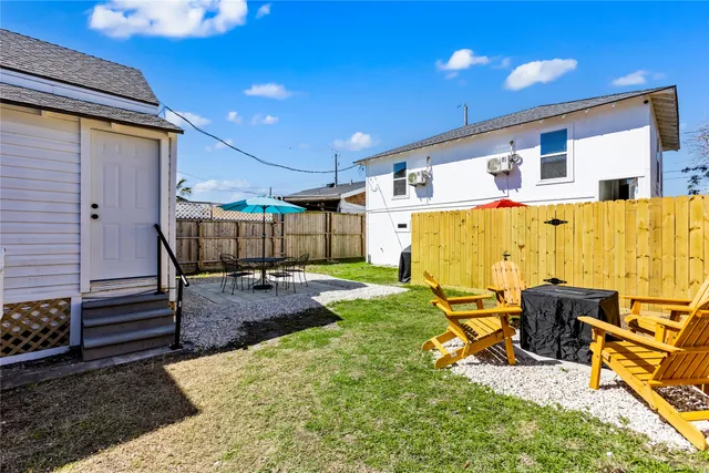 a view of a backyard with furniture