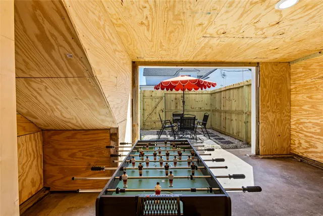 a view of a patio with a table and chairs