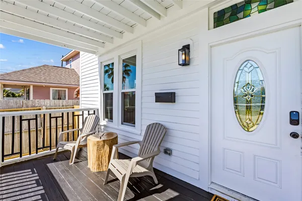 a view of a two chairs in the balcony
