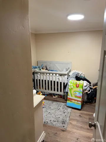 a bedroom with furniture and a wooden floor