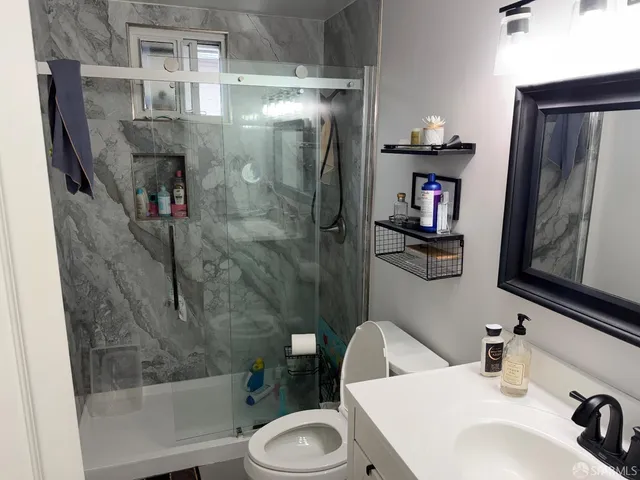 a bathroom with a sink toilet and shower