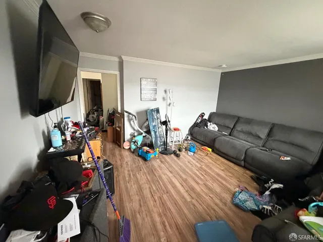 a living room with furniture and a flat screen tv