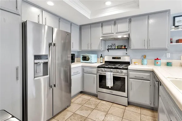 a kitchen with cabinets a stove and a refrigerator