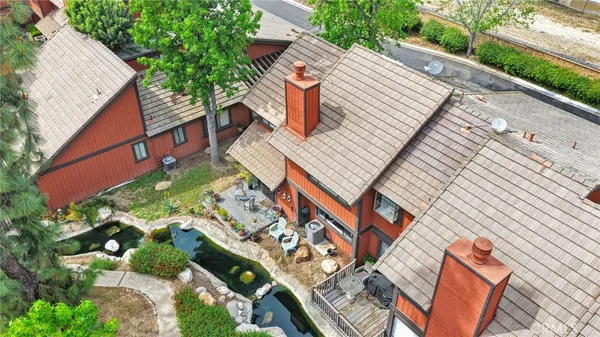 an aerial view of residential houses with outdoor space and river
