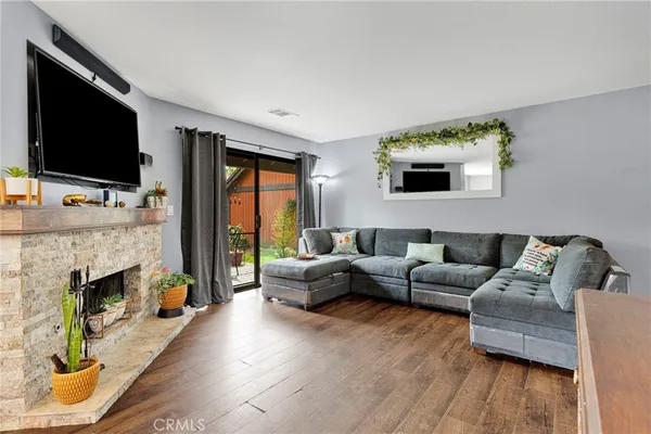 a living room with furniture fireplace and flat screen tv
