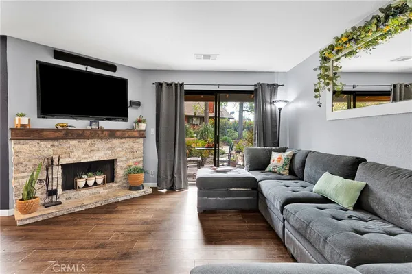 a living room with furniture large window and a fireplace