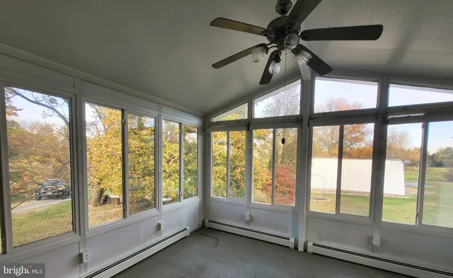 a view of room with window and a ceiling fan