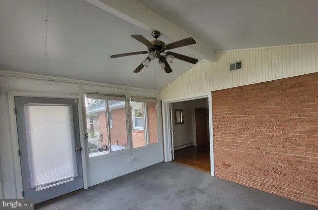 a view of a livingroom with a ceiling fan and window