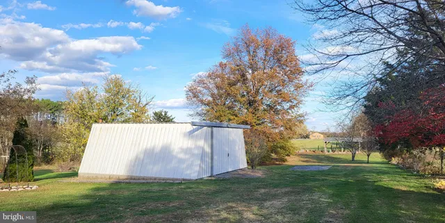 a view of outdoor space with garden and trees