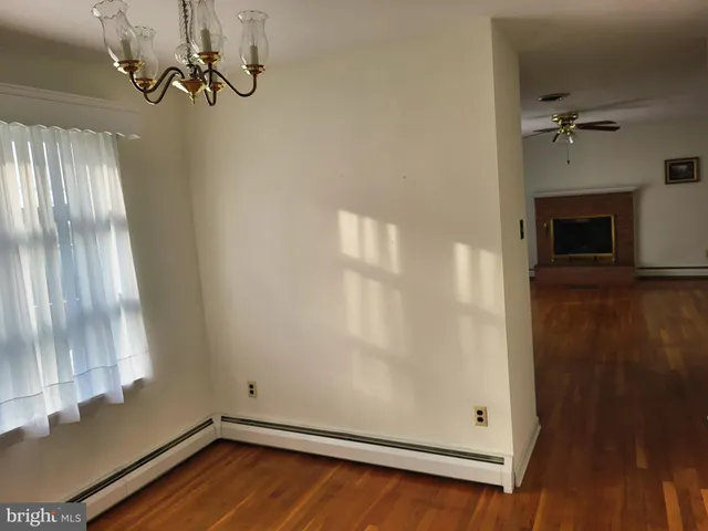 a view of a livingroom with wooden floor and a window