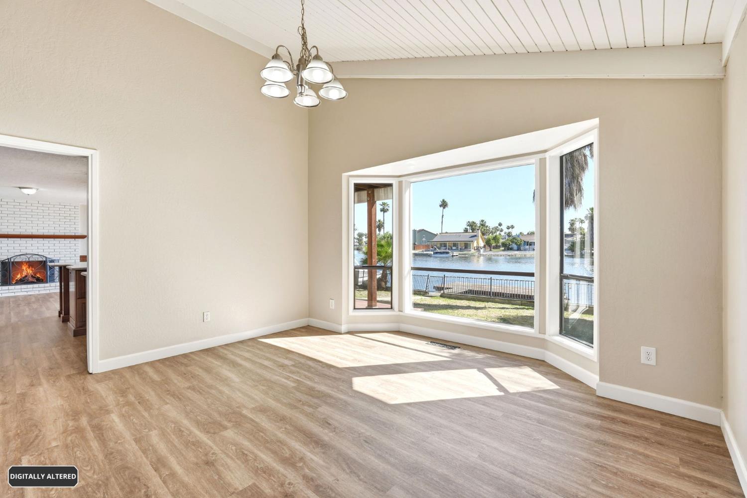 5501 Riverlake Road Discovery Bay, CA 94505 - Photo 16 of 60 a view of an empty room with wooden floor and a window