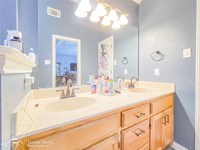 a bathroom with a sink a vanity and a mirror