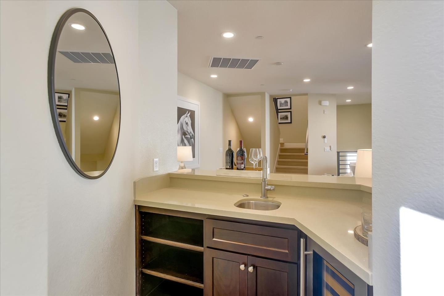402 Neves Road San Mateo, CA 94403 - Photo 14 of 31 a bathroom with a sink a vanity a mirror and a shower