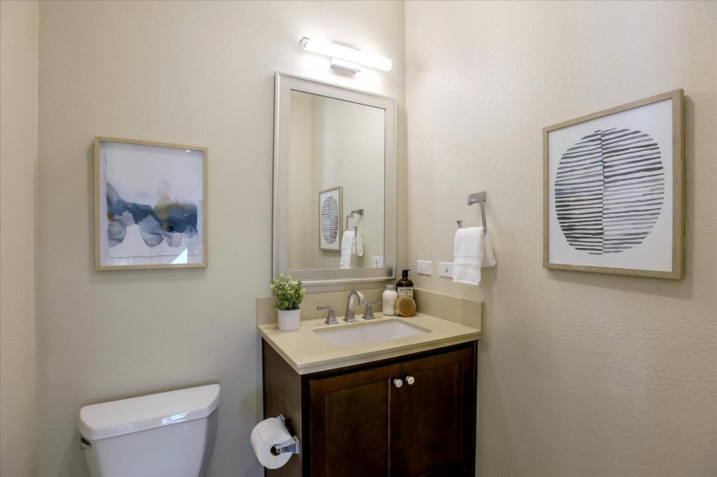 402 Neves Road San Mateo, CA 94403 - Photo 15 of 31 a bathroom with a toilet sink and mirror