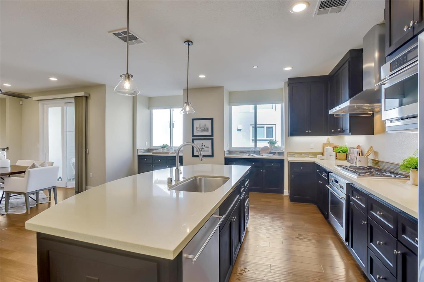 402 Neves Road San Mateo, CA 94403 - Photo 8 of 31 a large kitchen with kitchen island a stove a sink a refrigerator and a center island