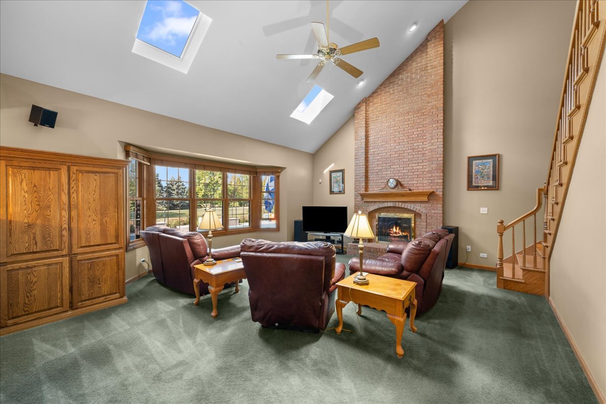 36W824 Red Gate Court St. Charles, IL 60175 - Photo 13 of 39 a living room with furniture a fireplace and a flat screen tv